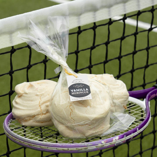 Packaged vanilla meringue on a tennis racket with a tennis court background